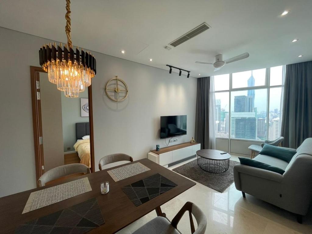 a living room with a dining table and a couch at Sky Suites By JK in Kuala Lumpur