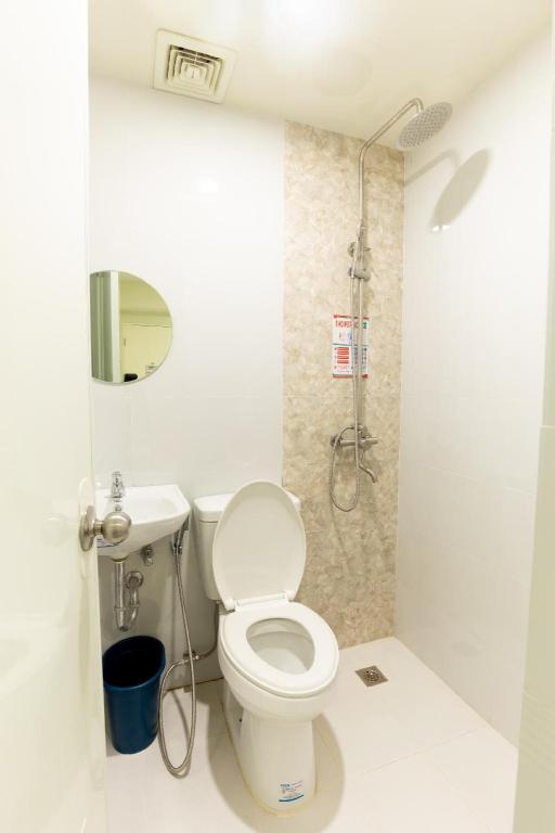 a bathroom with a toilet and a shower at Astrotel Cebu in Cebu City