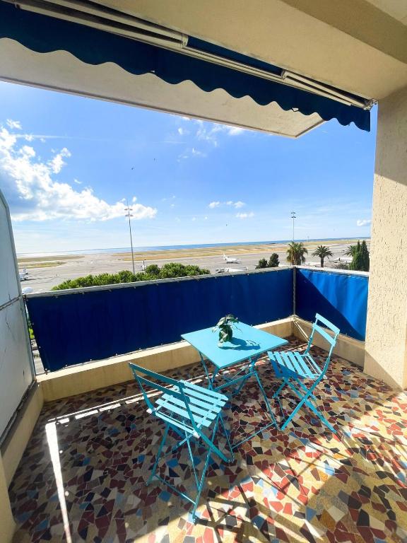 une table et des chaises sur un balcon avec vue sur la plage dans l'établissement Appartement Promenade des Anglais, à Nice