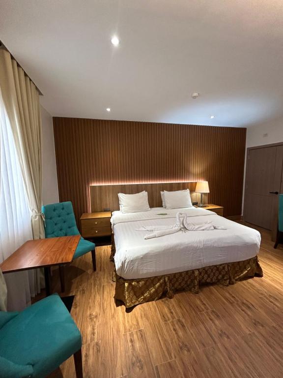 Postel nebo postele na pokoji v ubytování DM Residente Hotel Inns & Villas