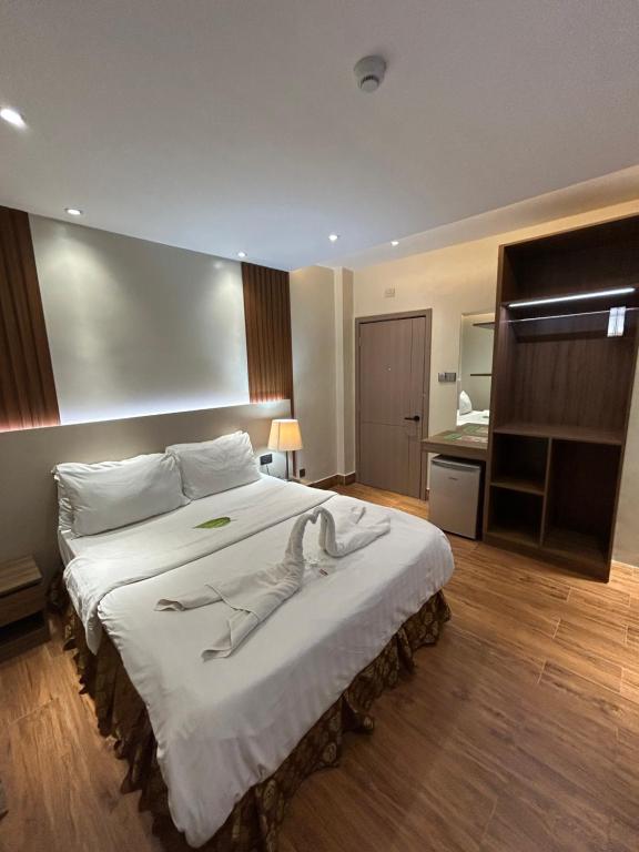 Postel nebo postele na pokoji v ubytování DM Residente Hotel Inns & Villas