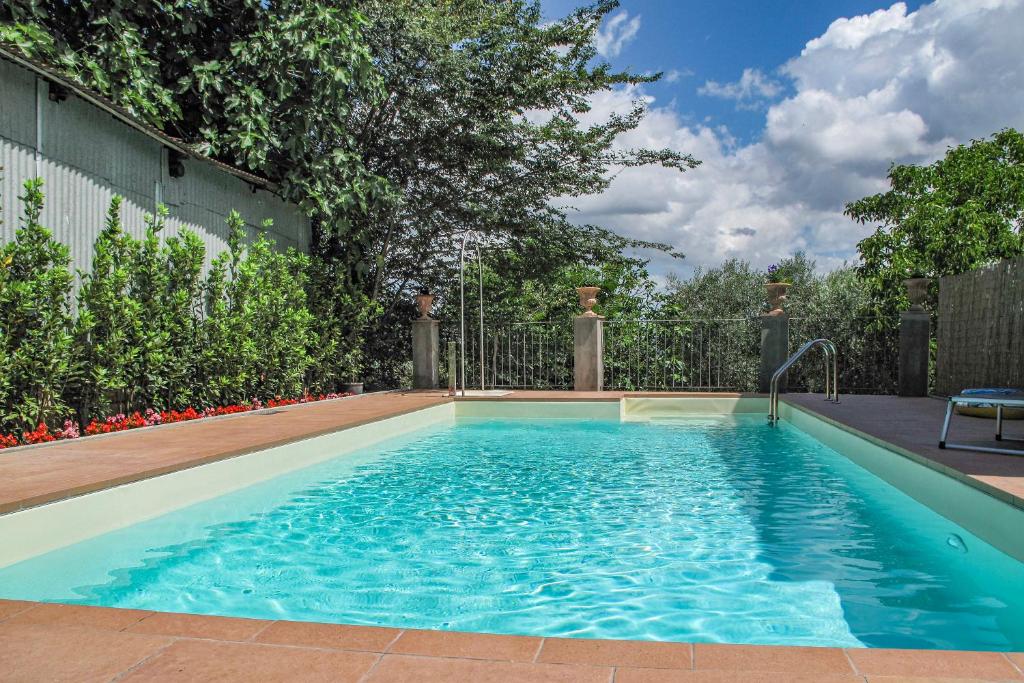 a swimming pool in a backyard with a fence at Francigena in Gambassi Terme