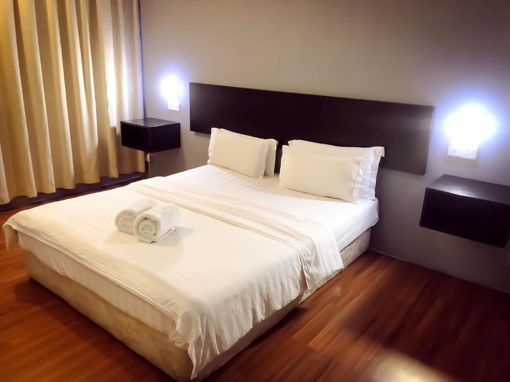 Postel nebo postele na pokoji v ubytování De Choice Hotel Tawau