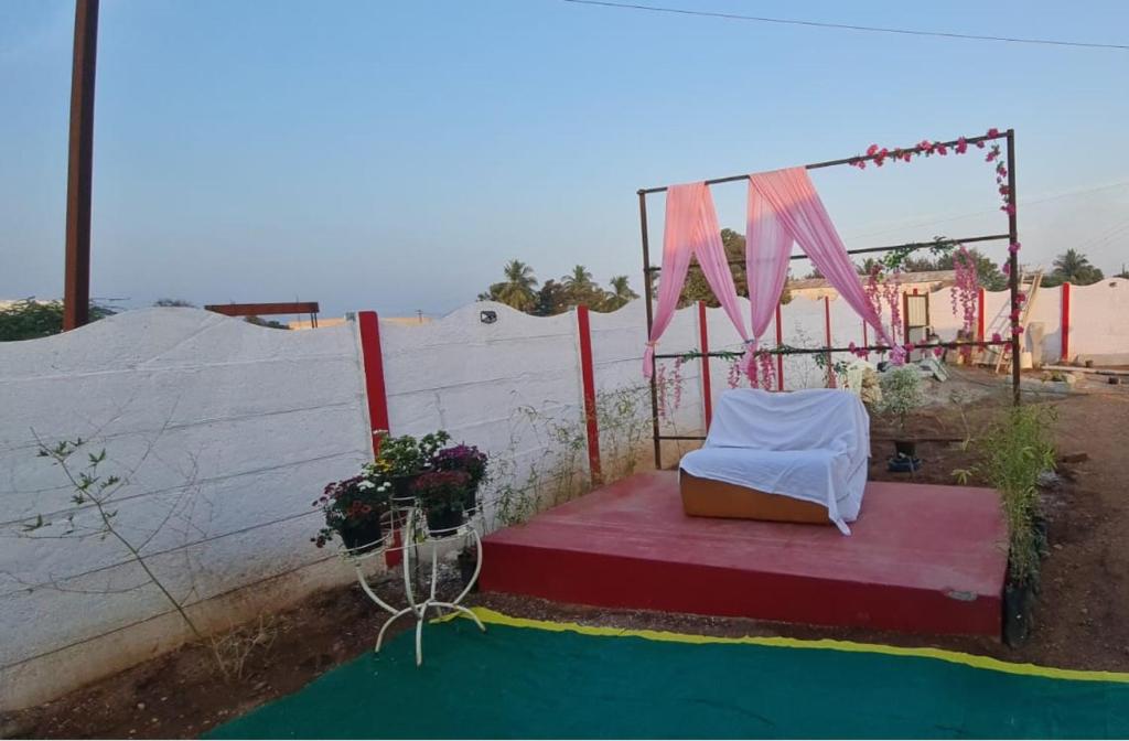 a chair sitting on a stage with a tent at Farm House With Swimming pool, Celebration area Below 5000 yadagirigutta Hyderabad in Wasalmari
