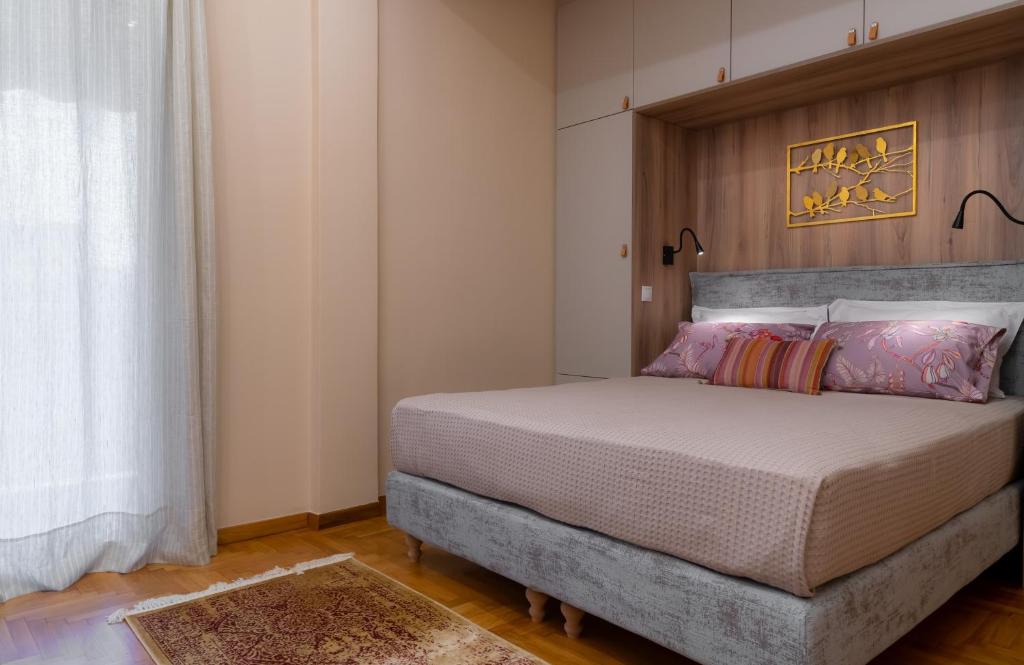 A bed or beds in a room at Absolute Athens Apartments