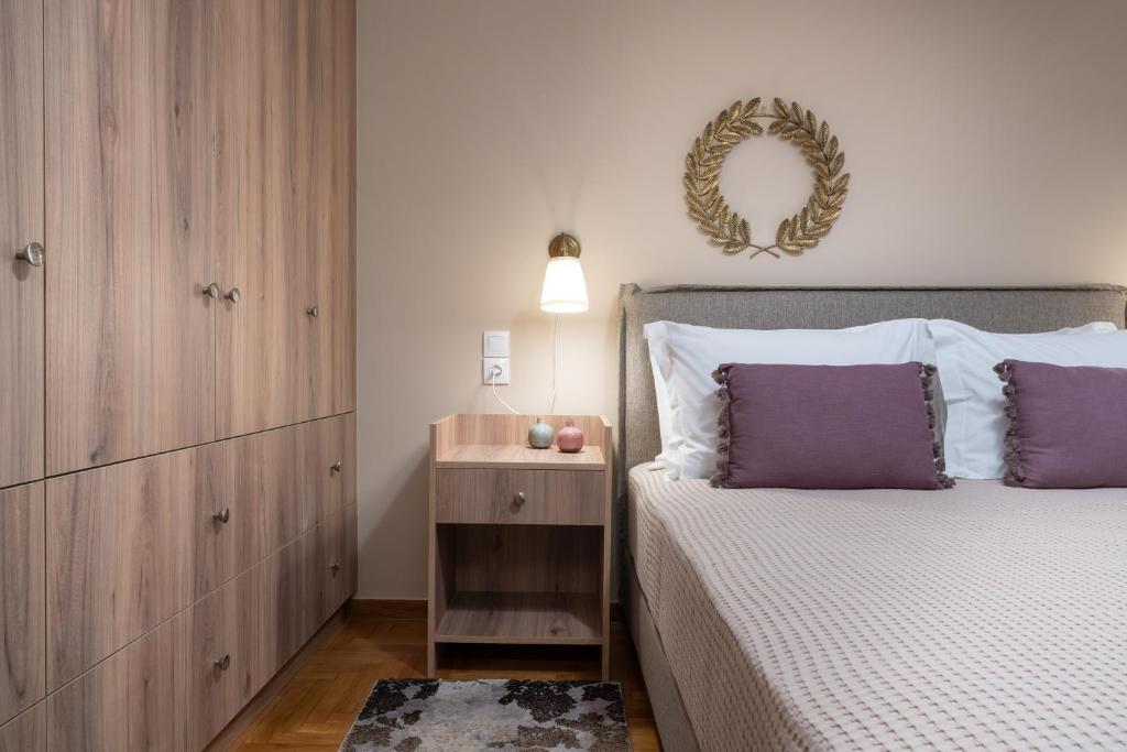 A bed or beds in a room at Absolute Athens Apartments