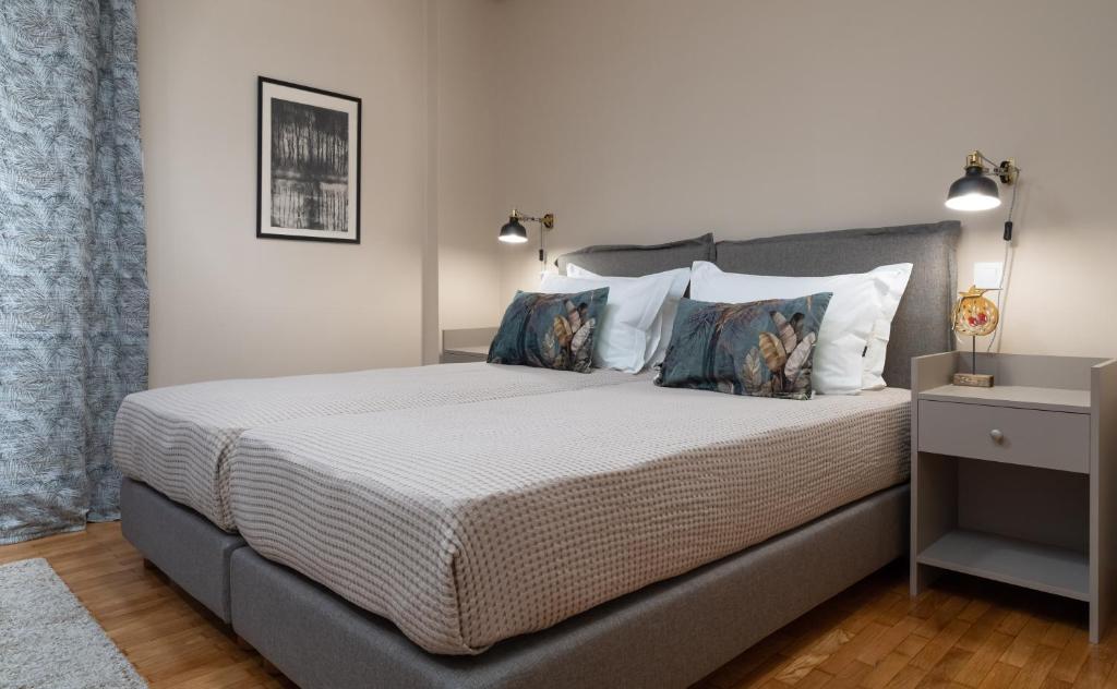 A bed or beds in a room at Absolute Athens Apartments