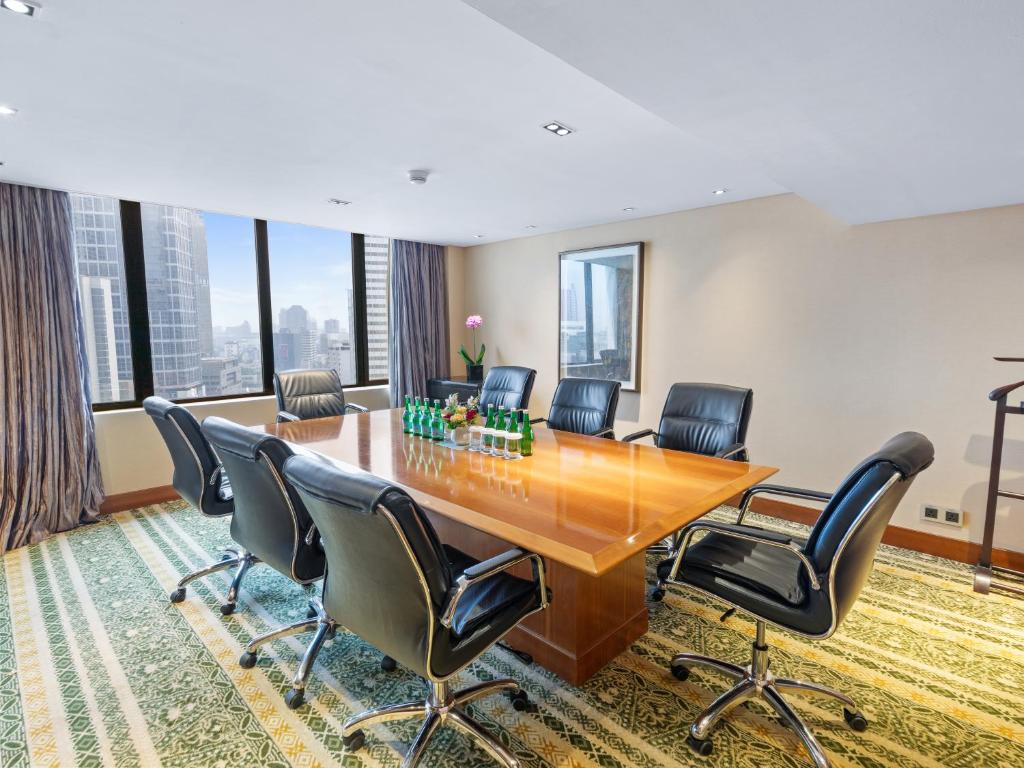 a conference room with a wooden table and chairs at Mandarin Oriental, Jakarta in Jakarta
