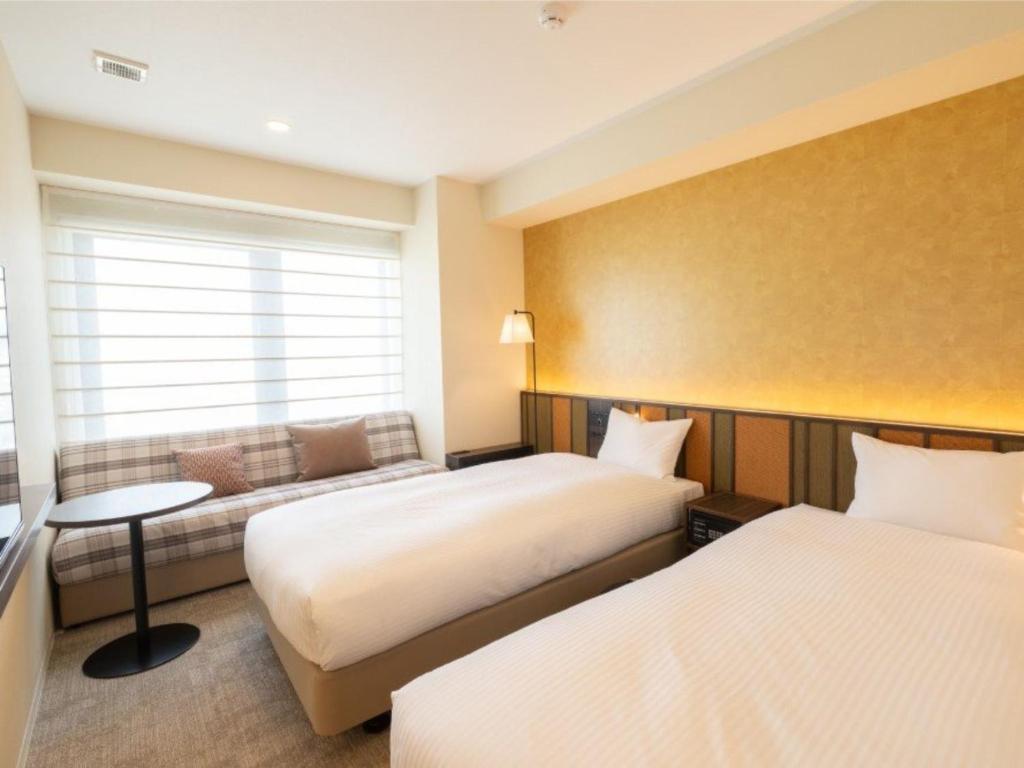 Postel nebo postele na pokoji v ubytování Loisir Hotel Kyoto Toji