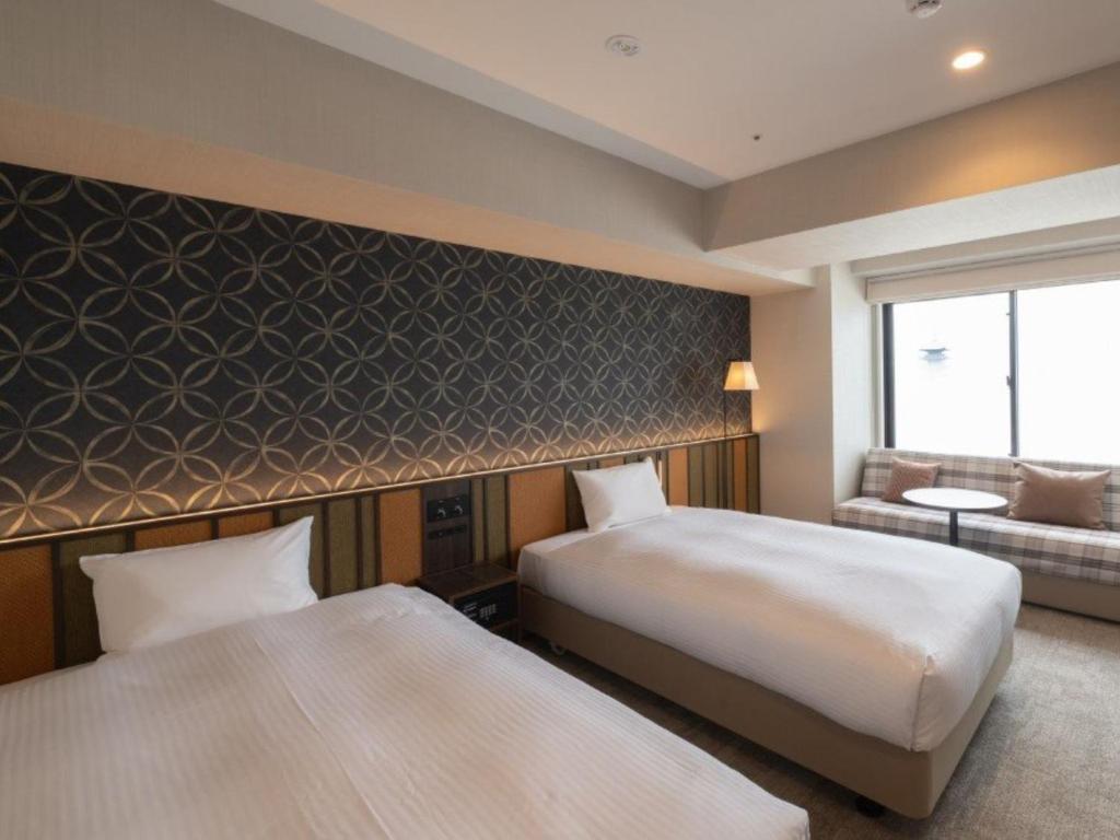Postel nebo postele na pokoji v ubytování Loisir Hotel Kyoto Toji