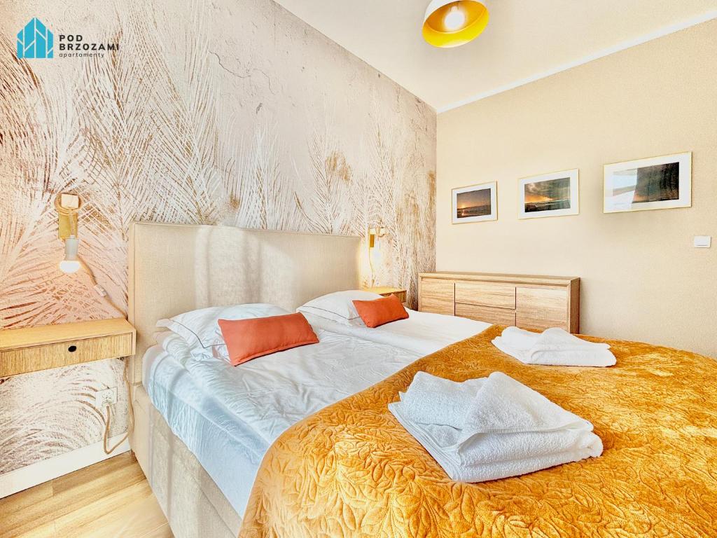 En eller flere senge i et værelse på Pod Brzozami Apartamenty Ku Morzu