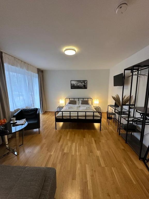 a living room with a bed and a couch at Hotel-Pension Asta in Munich