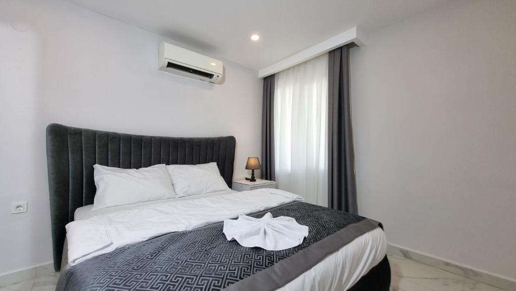 a bedroom with a large bed with a black headboard at Elite Luxury Suite - City 3 in Alanya