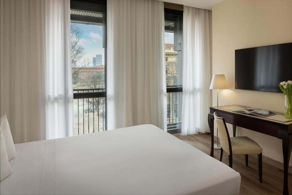 Postel nebo postele na pokoji v ubytování UNA HOTELS Cusani Milano
