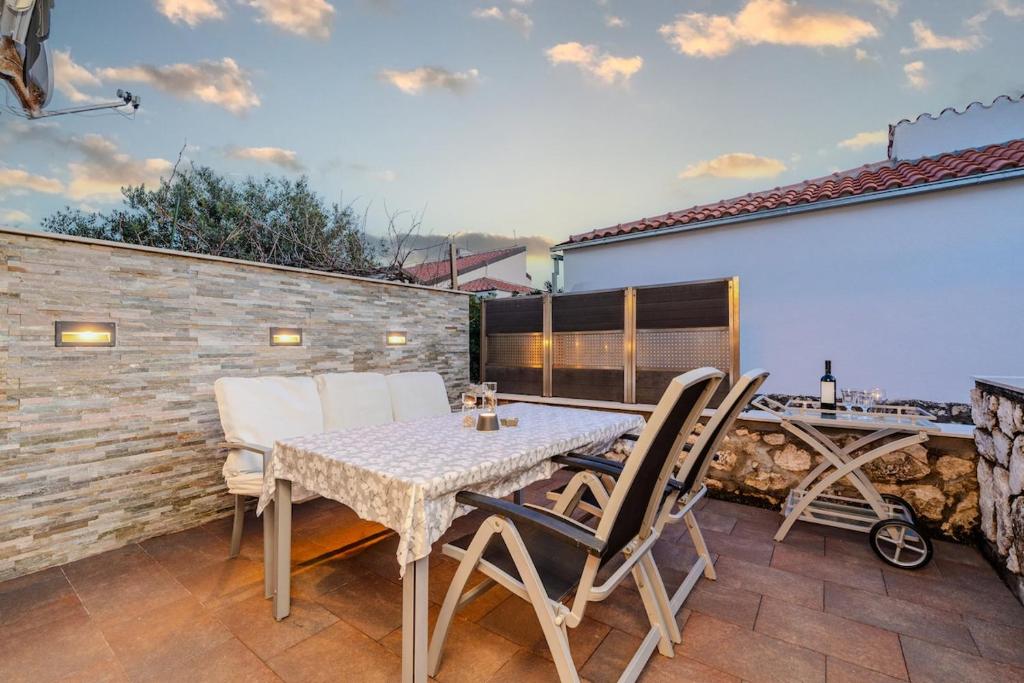 a patio with a table and chairs on a balcony at Boba lovely apartment close to Zrce beach in Gajac