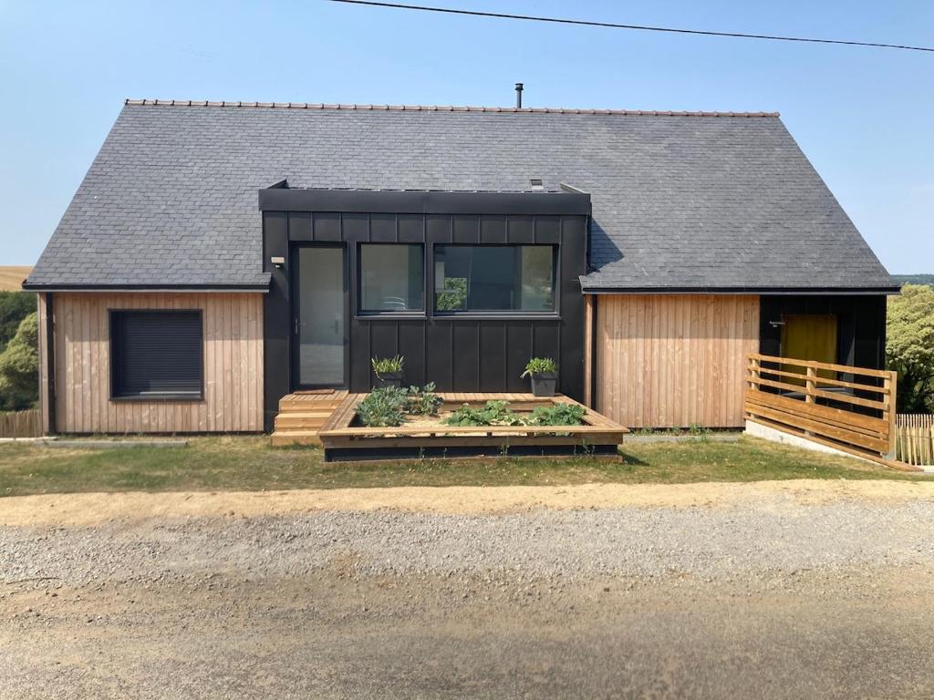une maison au toit noir et en bois dans l'établissement Eco-friendly house, à Saint-Nic