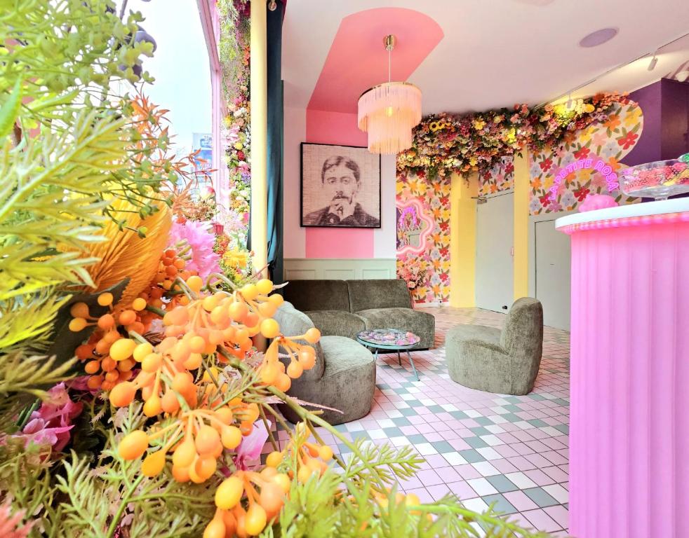 a lobby with a bunch of plants and flowers at Hotel La Petite Rosa in Paris