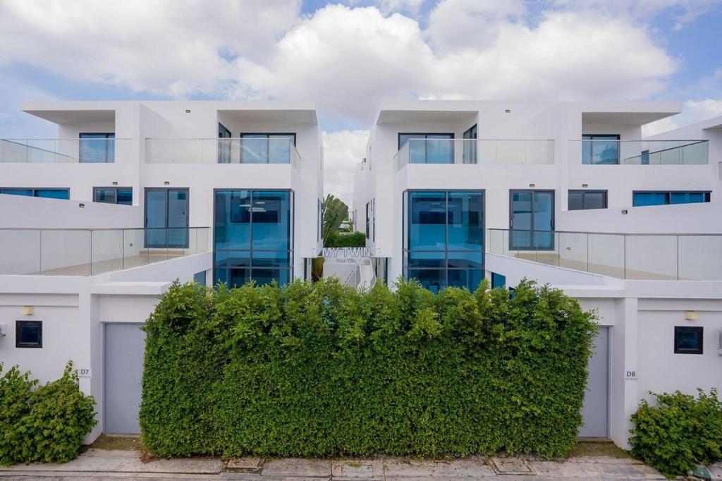 an apartment building with a hedge in front of it at My Havana, pool villa in Ban Nong Pru