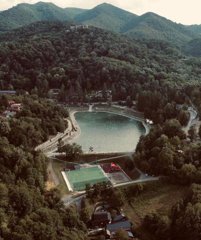 an aerial view of a lake in the middle of a mountain at OraHouse in Orahovica
