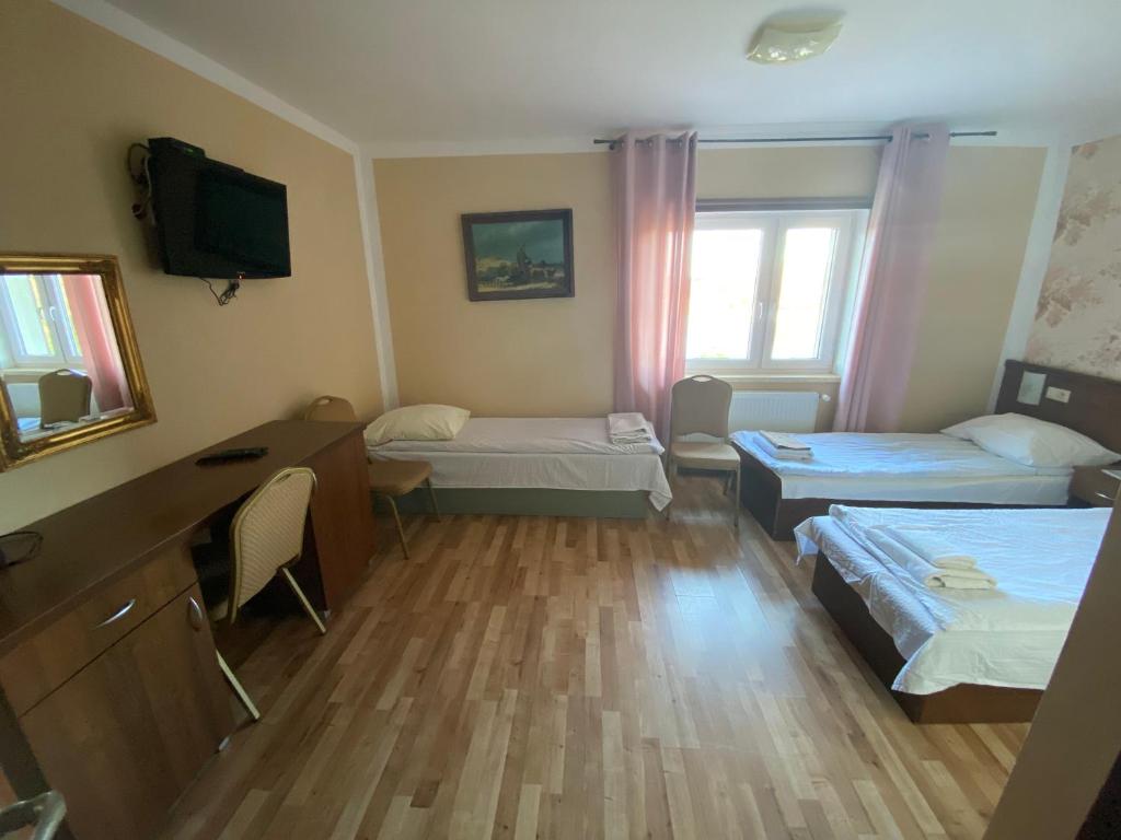 Postel nebo postele na pokoji v ubytování Hotelik Wulpink Majdy Olsztyn