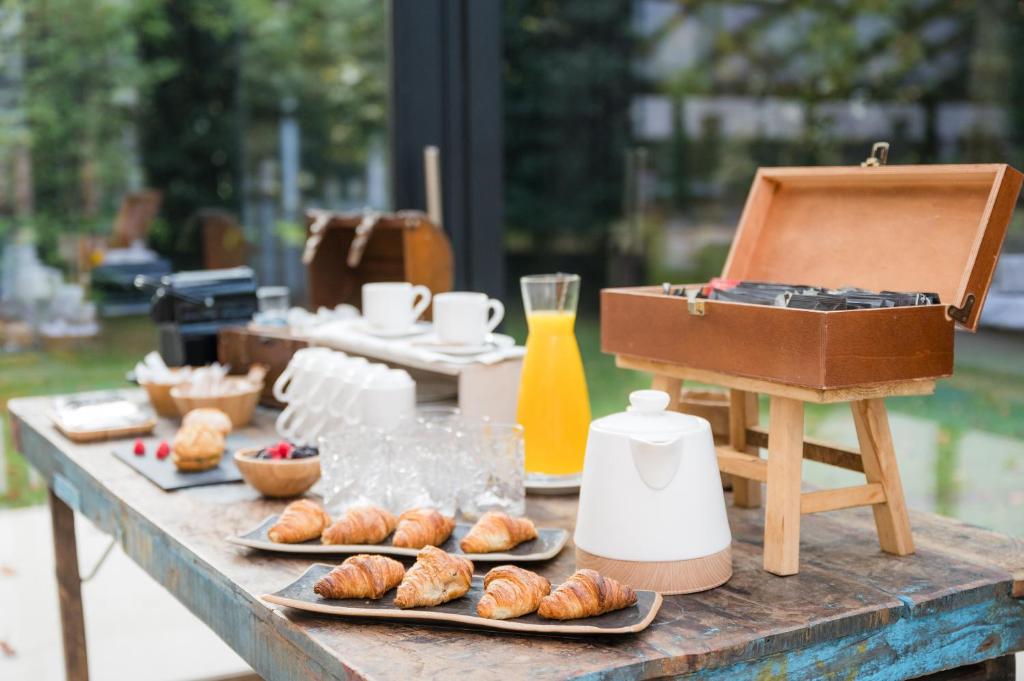 a table topped with plates of pastries and a blender at Castilla Termal Solares in Solares