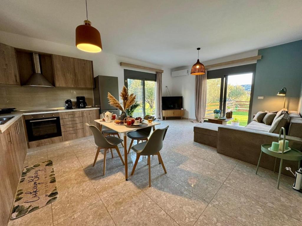 a kitchen and living room with a table and chairs at Arokaria Seaview House in Koskinou