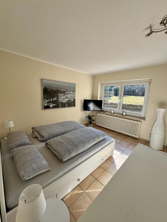 a bedroom with a bed and two pillows on it at Haases Ferienwohnung in Remscheid