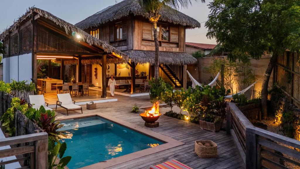 an outdoor patio with a pool and a house at VILLA COLIBRI Guriú in Guriú