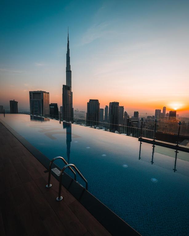 a swimming pool on top of a building with a city skyline at Paramount Hotel Midtown in Dubai