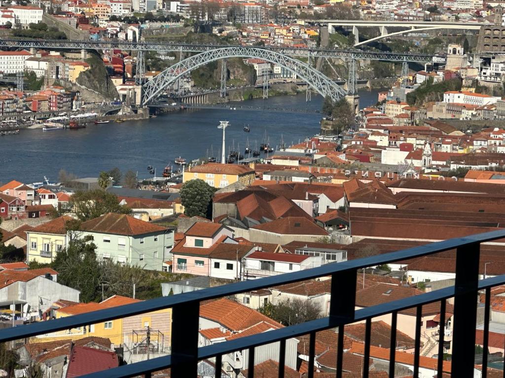 a view of a city with a river and a bridge at New Douro 908 with pool shared and parking in Vila Nova de Gaia