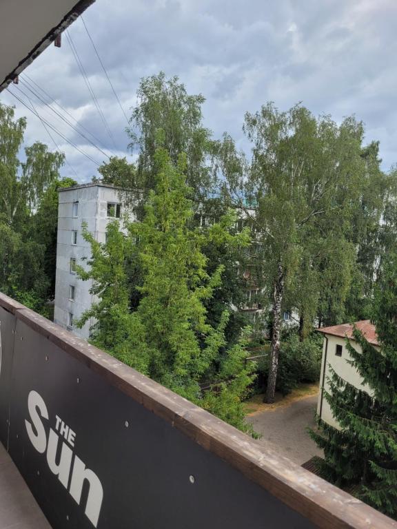 a view from the balcony of a building with trees at WHITE APARTMENTS free parking self check-inn in Rīga