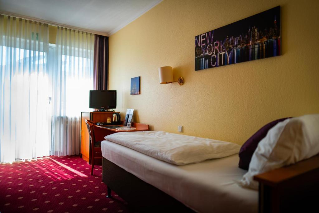Postel nebo postele na pokoji v ubytování Hotel Boulevard
