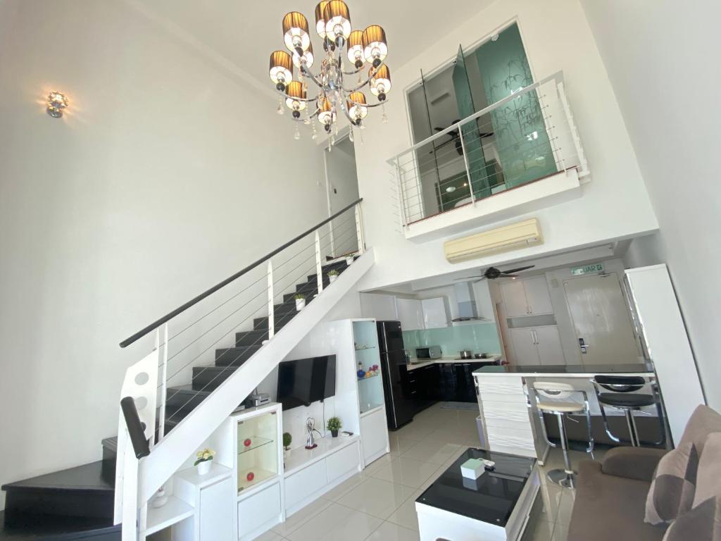 a living room with a staircase in a house at Duplex 775sq ft near Mid Valley in Kuala Lumpur