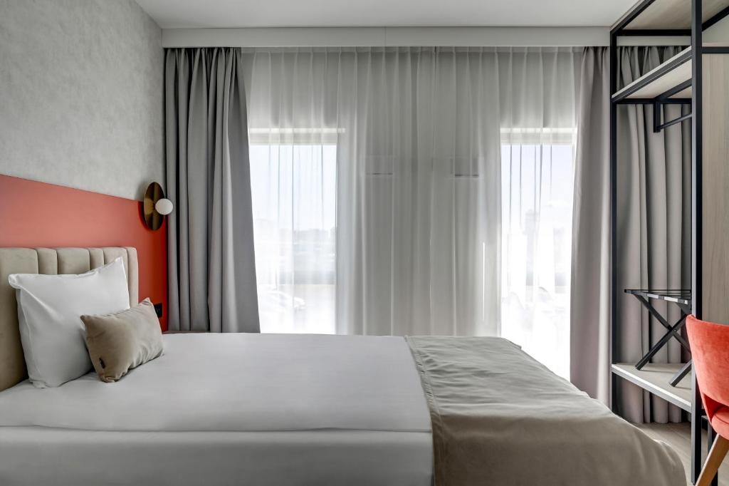 Postel nebo postele na pokoji v ubytování Hotel Milo Gdansk Airport