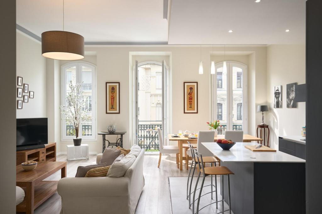 un salon avec un canapé et une table dans l'établissement Sunlight Properties - Gisele - Nice hyper central, 1 bedroom with large living room, à Nice