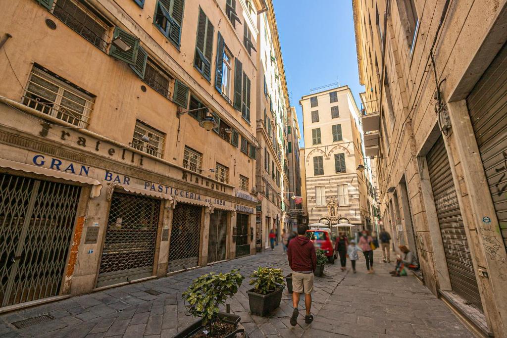 a man walking down a street in a city at Guest House Genova Holiday in Genova