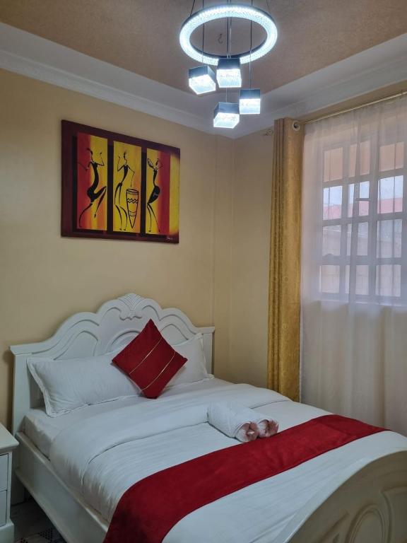 a bedroom with a bed with a stuffed animal on it at D & C Homes in Eldoret