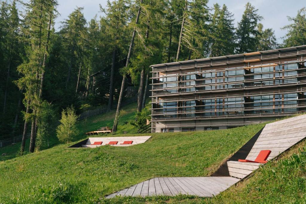 a building on top of a hill with a ramp at Vigilius Mountain Resort in Lana