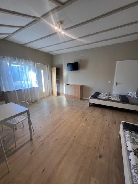 a large room with a bed and a wooden floor at Daytona Monteur Apartment in Rodenbach