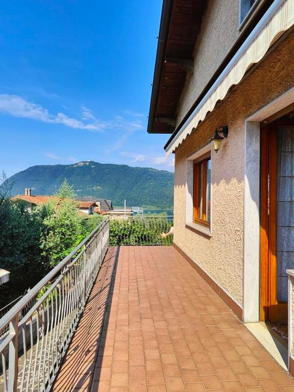 a walkway next to a building with a mountain in the background at Iseo Lake Terrace in Sale Marasino