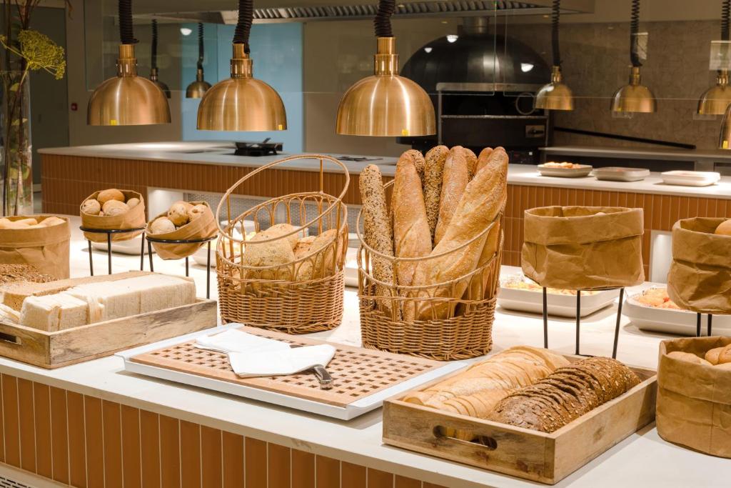 a bakery with baskets of bread on a counter at Plus Fariones Suite Hotel in Puerto del Carmen
