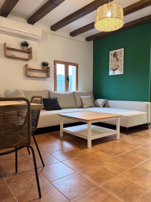 a living room with a couch and a table at Casa Tramontana CR Los Cuatro Vientos in Moratalla