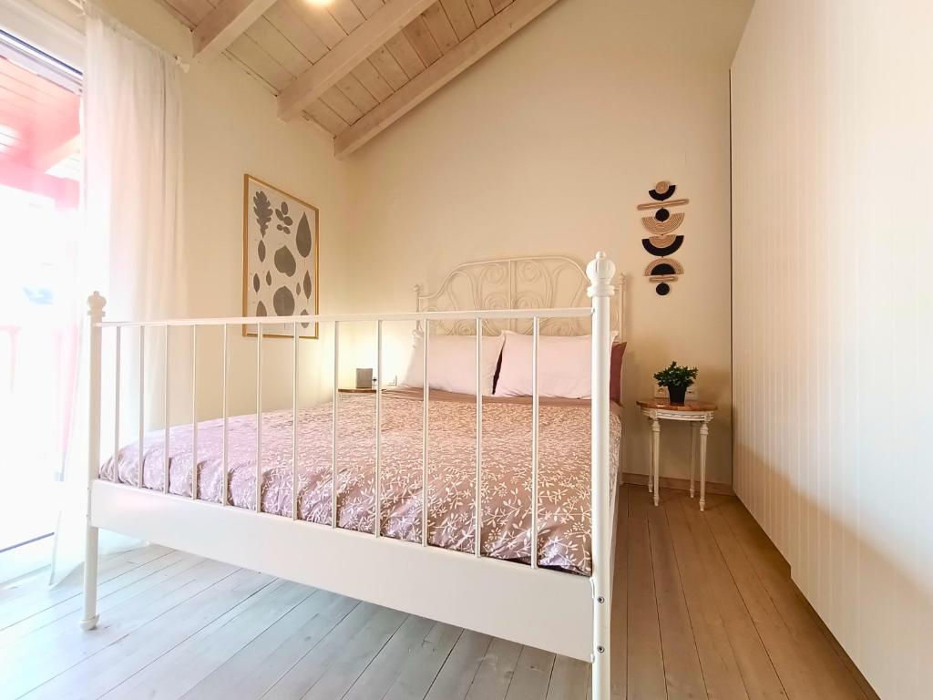 a bedroom with a white bed in a room at "Wonderland" Nest Nafplio in Nafplio