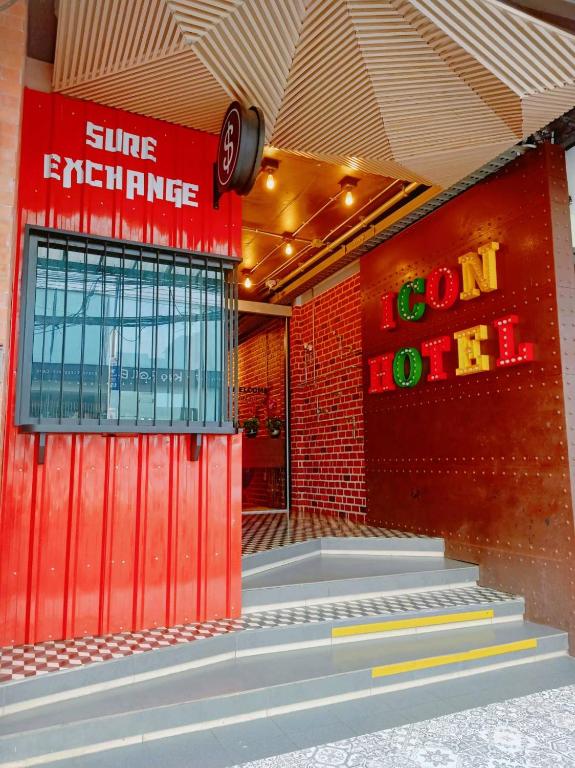 a red building with a sign on the side of it at Icon Hotel Hatyai in Hat Yai