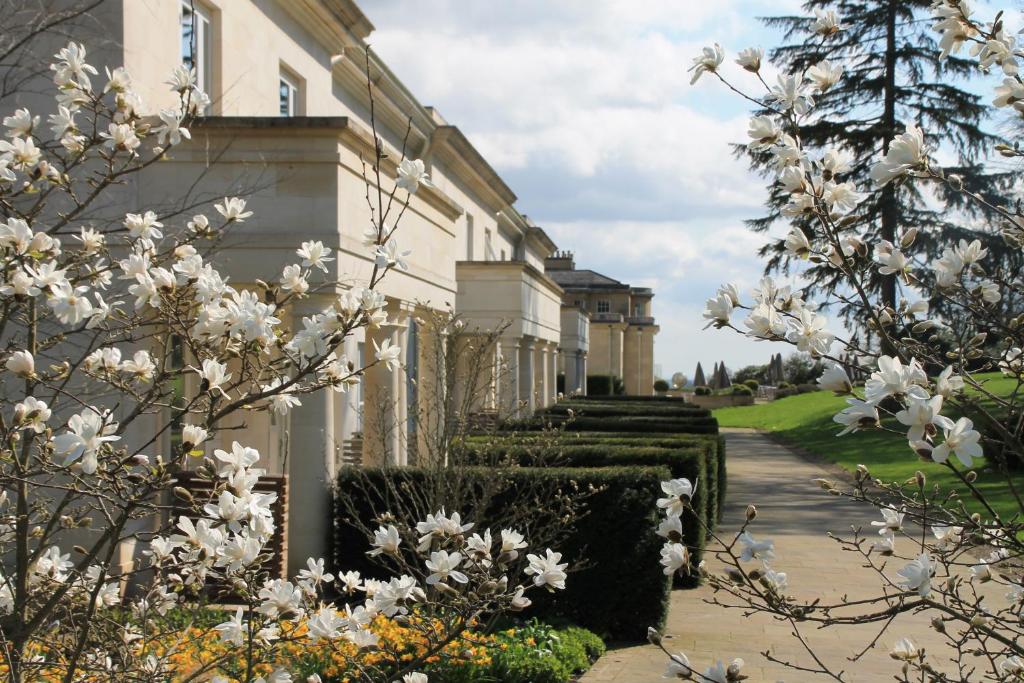 a house with white flowers on the side of it at Rudding Park in Harrogate