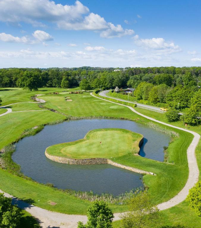 an overhead view of a golf course with a pond at Rudding Park in Harrogate