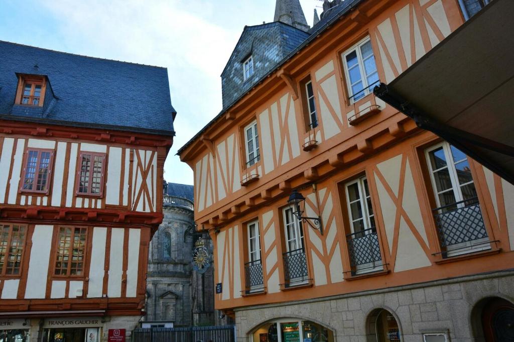 two buildings are next to each other on a street at Charmant appartement proche centre-ville in Vannes