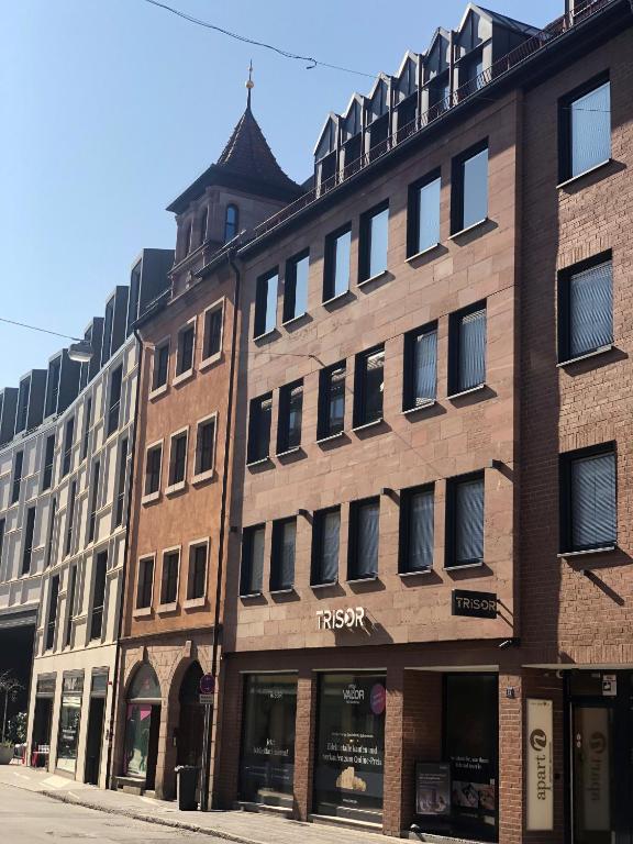 a large brick building on the corner of a street at apart N serviced apartments in Nuremberg