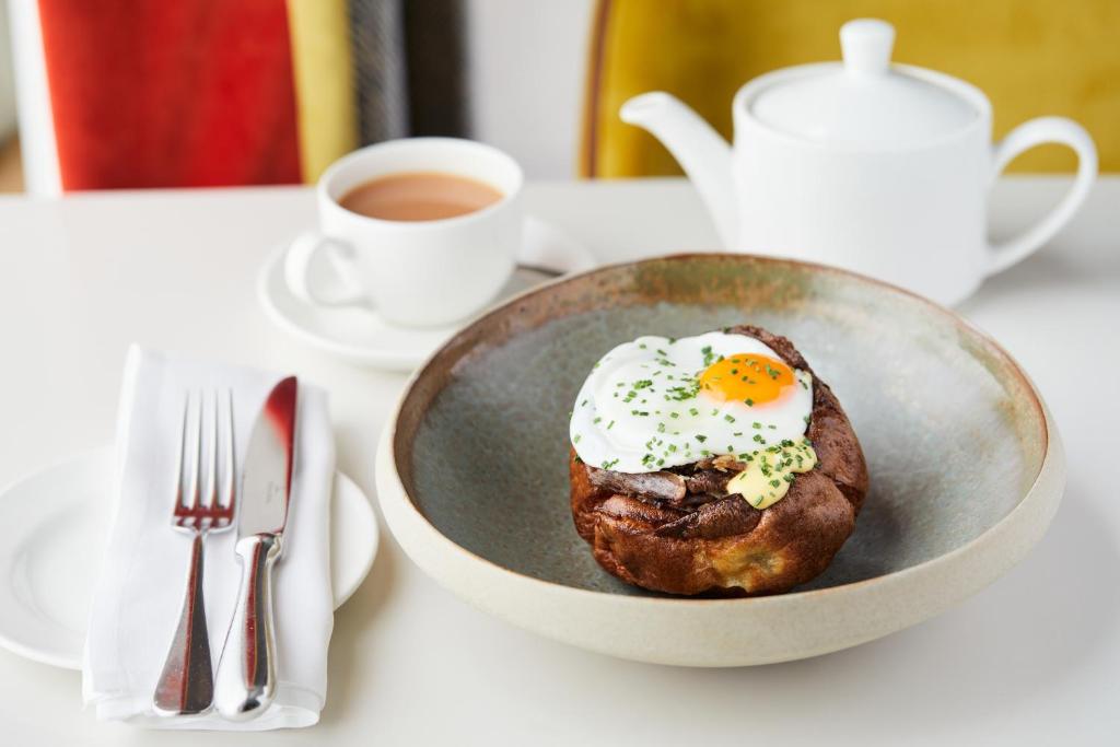 a plate of food with an egg on top on a table at Rudding Park in Harrogate