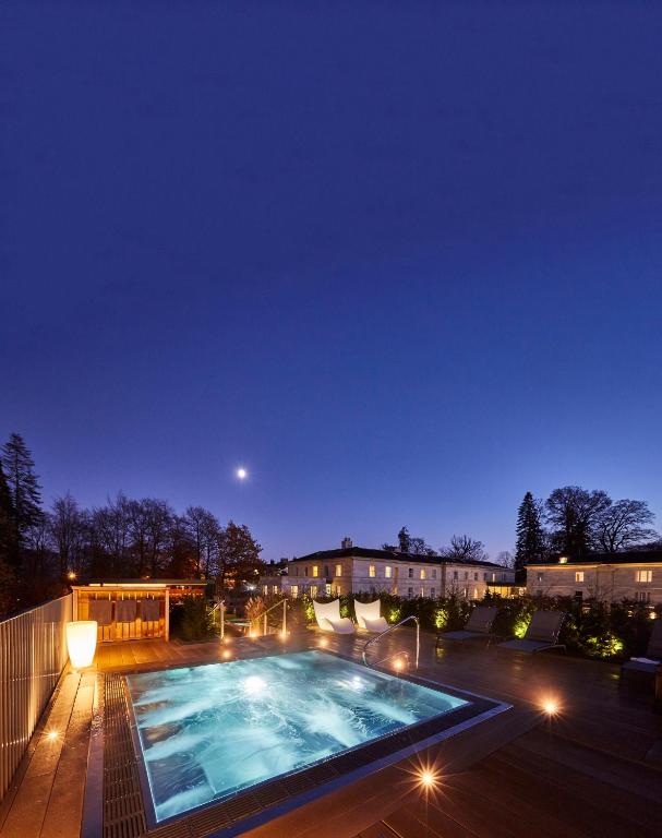 a swimming pool at night with the moon in the sky at Rudding Park in Harrogate
